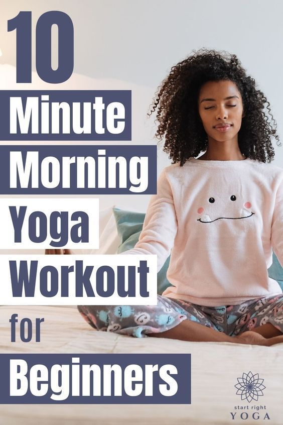 a woman sitting in the middle of a bed doing yoga