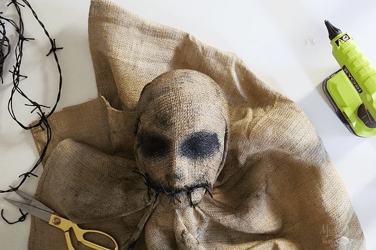 a cloth with a skull on it next to some scissors and other items that include wire