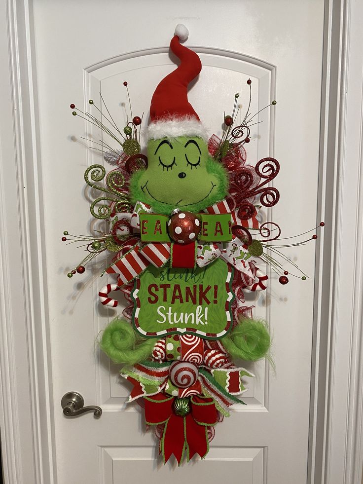 a door decorated with an elf's head and candy canes on the front