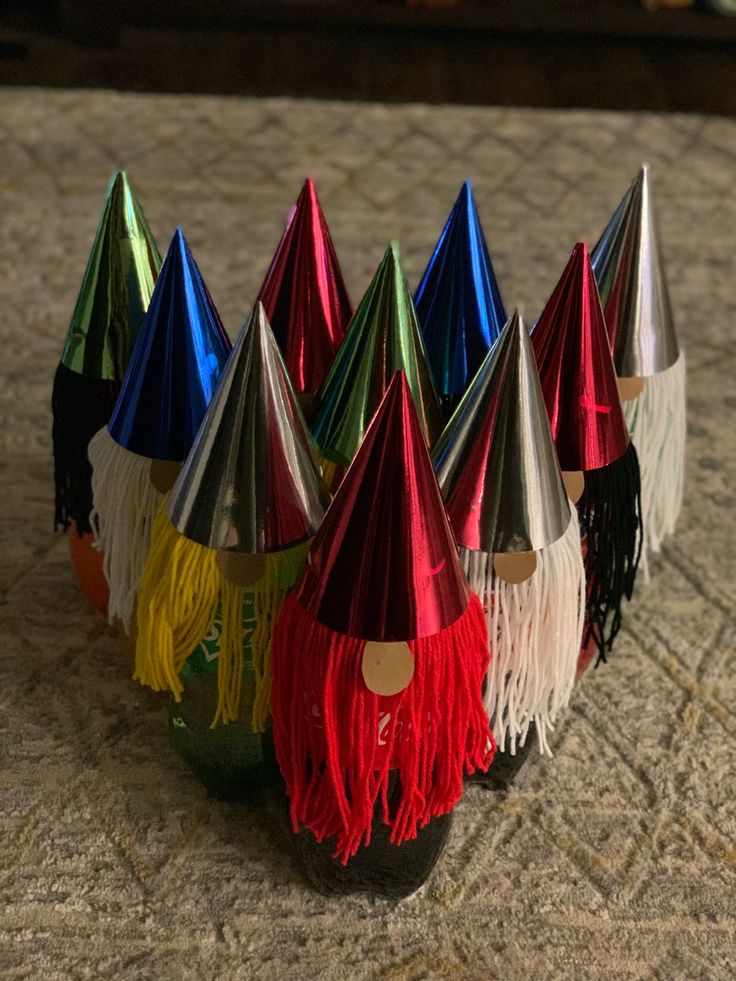 several party hats with tassels on them