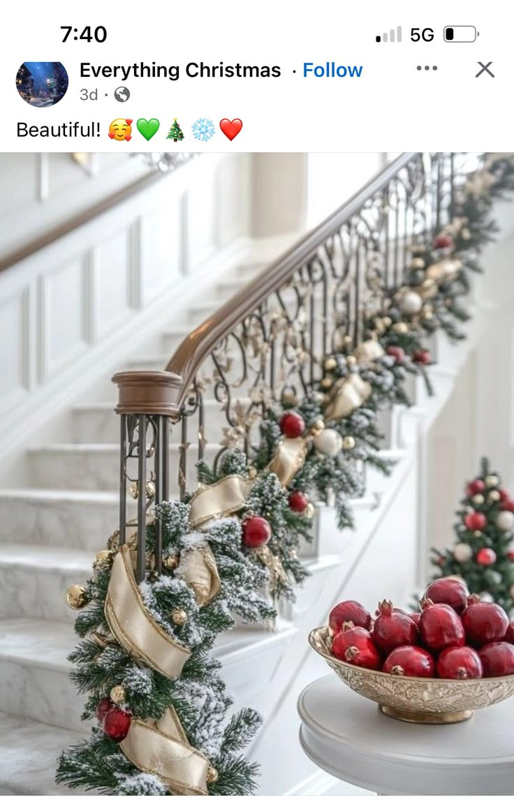 christmas decorations on the banisters and stairs are decorated with red balls, gold ribbons, and bells