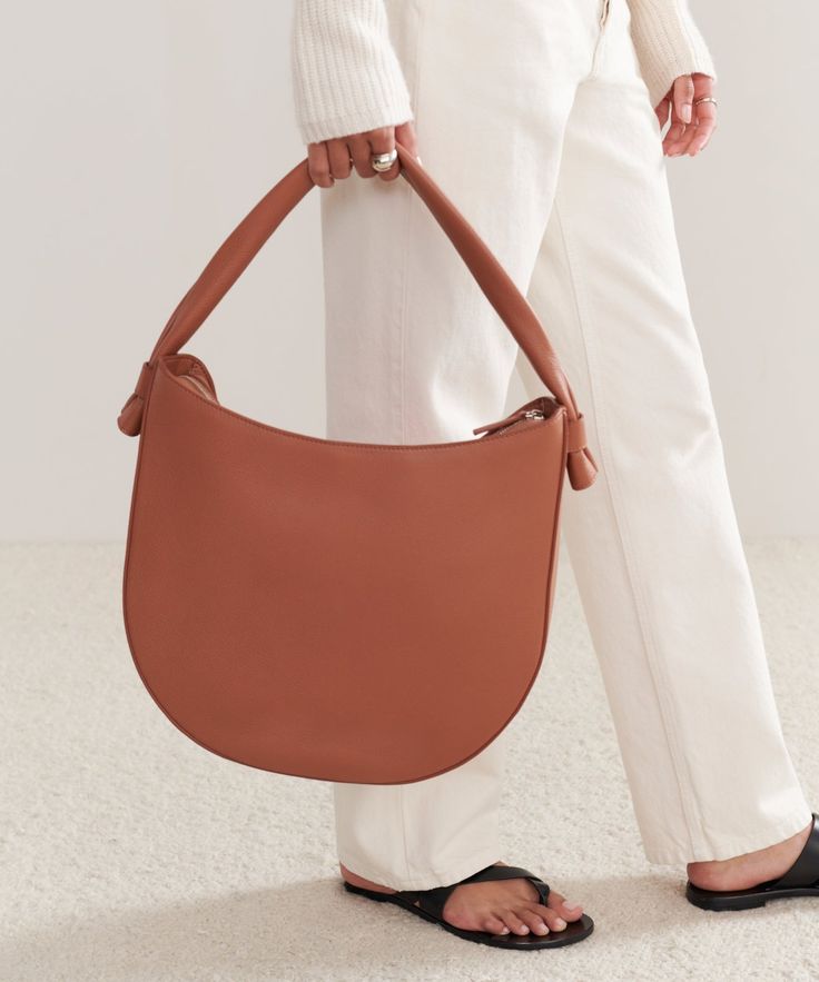 Loren Tote SaddleThe search for the bring-everywhere bag ends here. Meet the Loren Tote—a refined take on the essential accessory. 100% soft leather. Made in Italy. Features suede lining and phone pocket inside. | Jenni Kayne Loren Tote Leather Shoulder Bag With Round Handle For On-the-go, Timeless Everyday Saddle Bag With Removable Pouch, Timeless Everyday Saddle Shoulder Bag, Chic Bucket Bag With Leather Lining For On-the-go, Smooth Grain Hobo Bag Tote For Work, Smooth Grain Hobo Bag In Tote Shape For Work, Smooth Grain Tote Hobo Bag For Work, Chic Bucket Bag With Smooth Grain For Work, Brown Smooth Grain Hobo Bag For Work