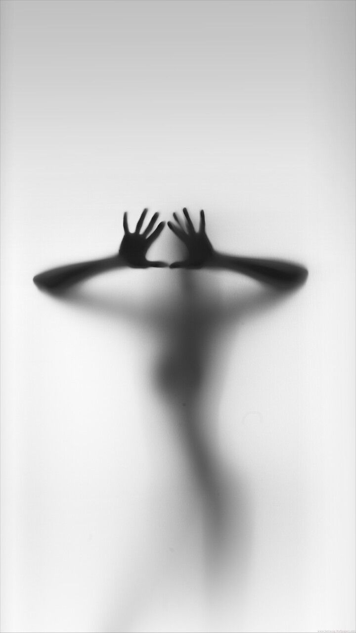 the shadow of a person holding their hands up