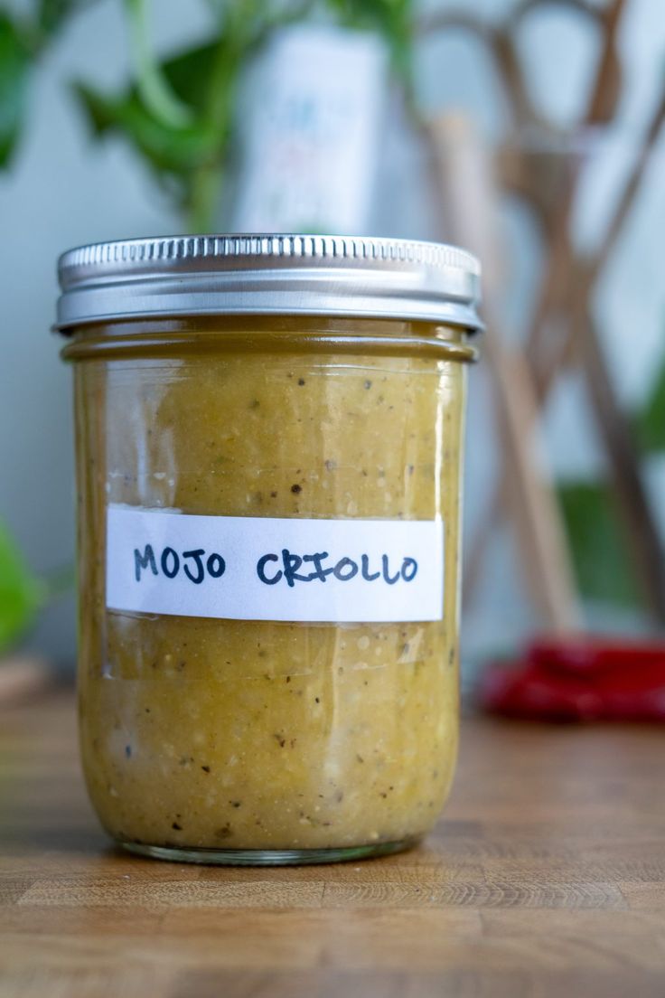 a jar of mustard sitting on top of a wooden table