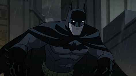 batman standing in the rain with his hands on his hips and looking at the camera