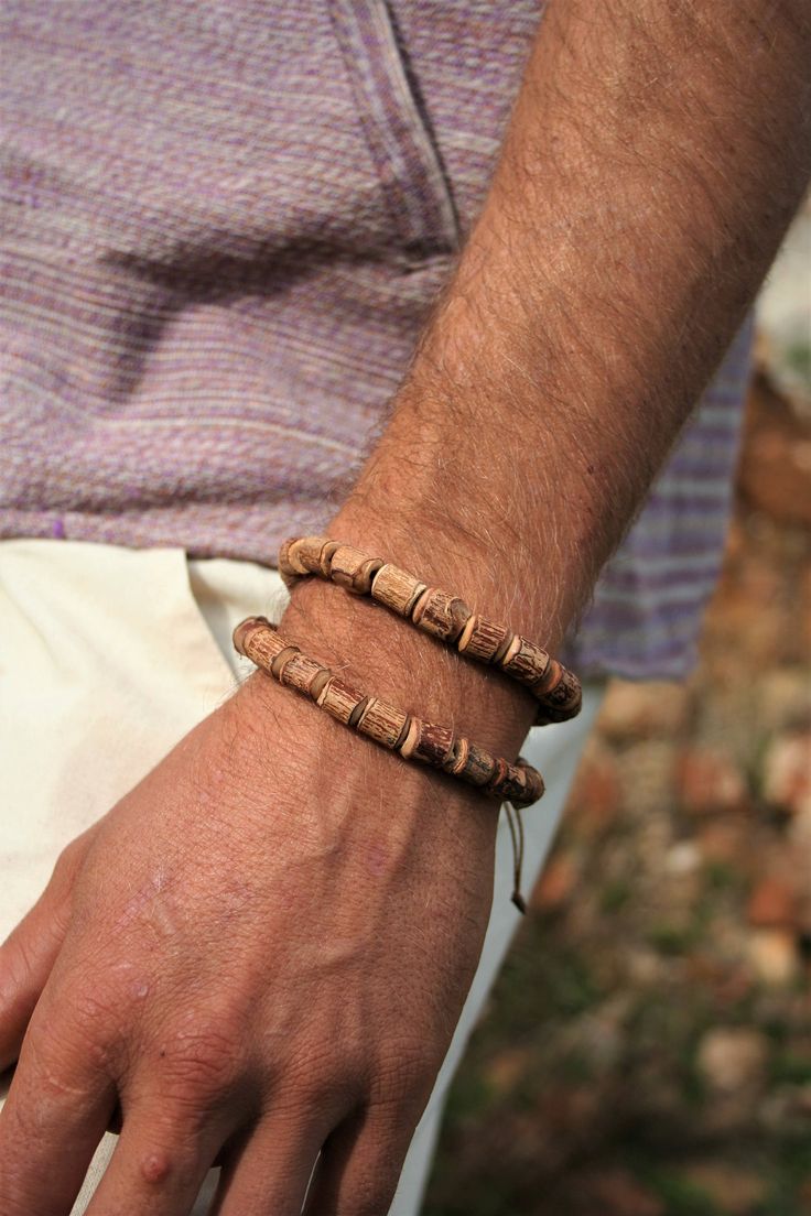 Handmade Tulsi Wood Tribal Bracelet, Adjustable Size, Unisex Big beads *Tulsi (Holy Basil) Wood Bracelet with 2 Strands. Pic 1-2 the model are wearing 2 bracelets (we recommend!) *Tulsi beads are worn traditionally in India for Purification and Protection and is thought to be the most sacred of woods. The plant of Tulsi is believed to be the incarnation of the Divine itself. Adjustable Wooden Beads Bracelet Bangle, Adjustable Wooden Beads Bangle Bracelets, Adjustable Wooden Beads Festival Bracelets, Adjustable Friendship Bracelet With Wooden Beads, Cottage Core Photoshoot, Tulsi Mala, Pokemon Fashion, Earthy Jewelry, Holy Basil