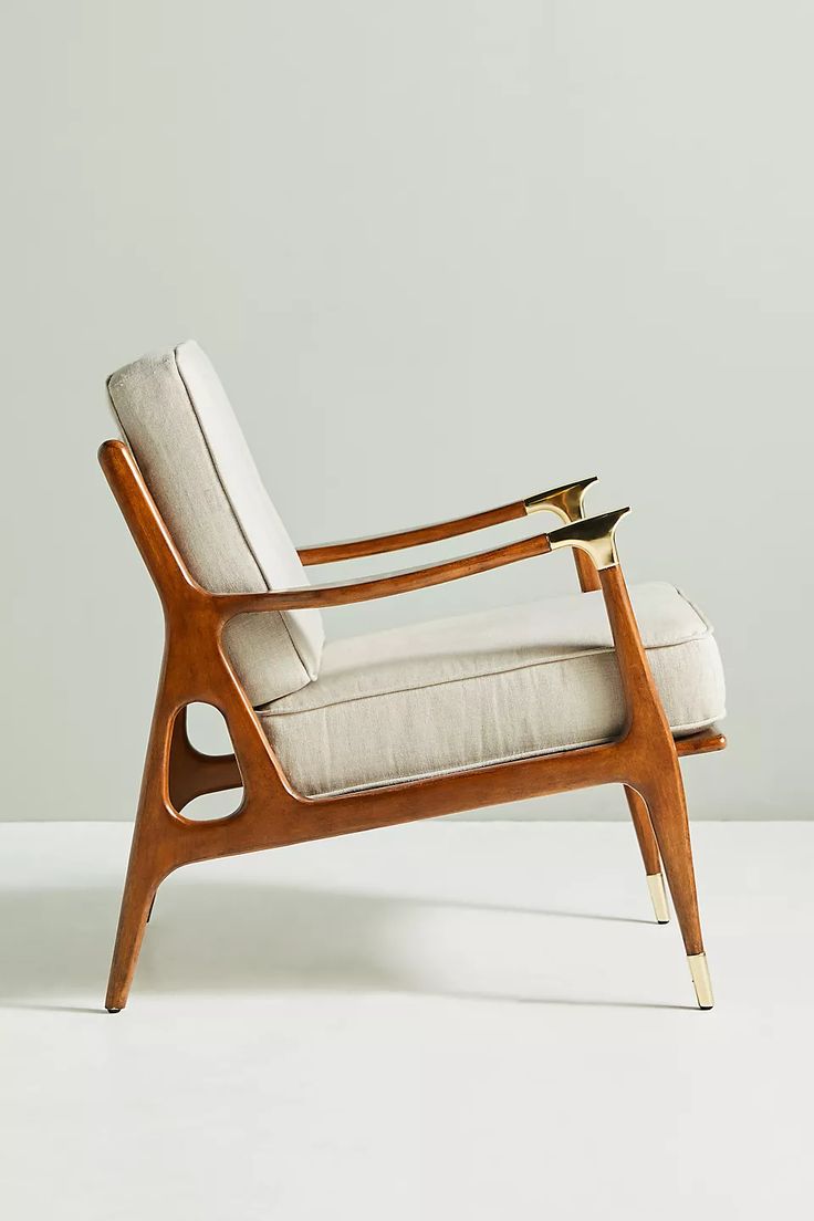 a wooden chair with white upholstered cushions