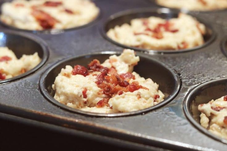 a muffin tin filled with cupcakes covered in bacon