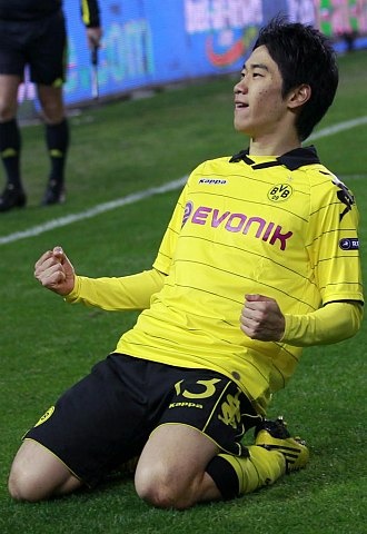 a man sitting on top of a soccer field