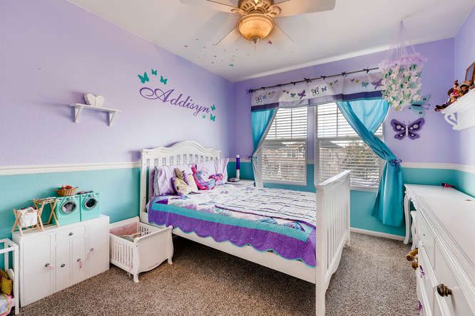 a child's bedroom with purple and blue walls