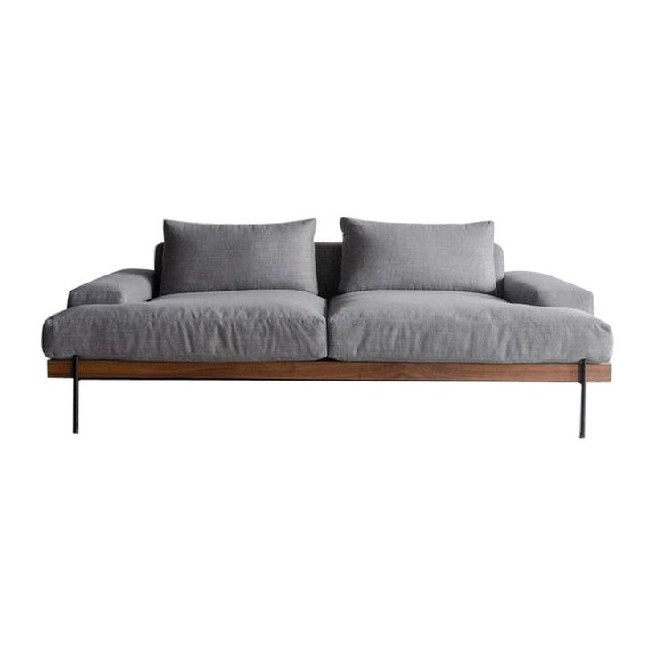 a gray couch sitting on top of a wooden frame