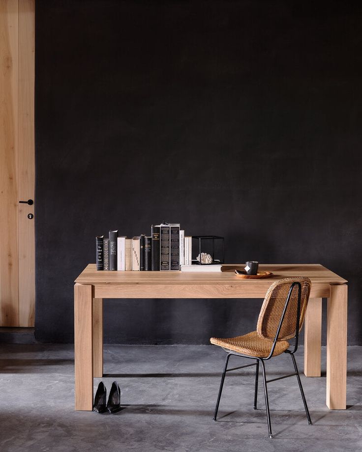 a wooden table sitting next to a pair of black shoes