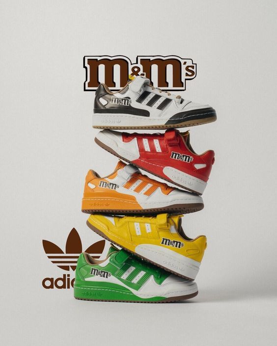 five pairs of adidas sneakers stacked on top of each other in front of a white background