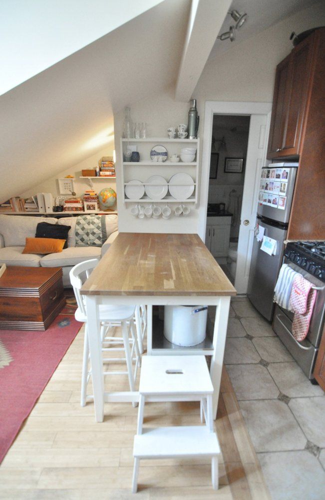 a kitchen with an island and stools in it