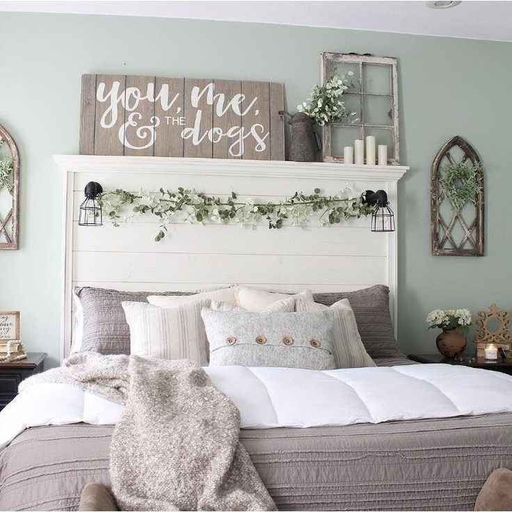 a white bed sitting in a bedroom next to a dresser and mirror on the wall