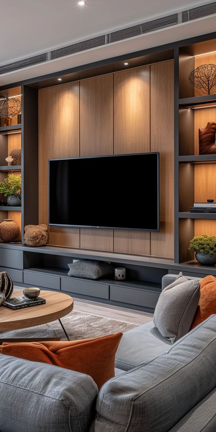 a living room filled with furniture and a flat screen tv mounted on a wall above it