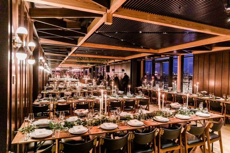 a long table with many plates and place settings is set up in the middle of an empty dining room