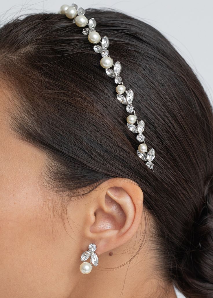 Delicate yet impactful, the Kamila Headband leaves all eyes on you. A vine of crystal flora is punctuated by lustrous pearls, with a raised silhouette subtly suggesting the height of a tiara. The fine headband base disappears into the hair, creating the sublime illusion of gems magically afloat. Pair with the matching Kaide Earrings. Wedding Headband Pearls, Wedding Headband With Rhinestones, Peal Headband, Bridal Headband Crystal, Pearl And Diamond Headband, Pearl Headband Wedding, Headband Crystal, Pearl Bridal Headband, Luxury Hair Accessories