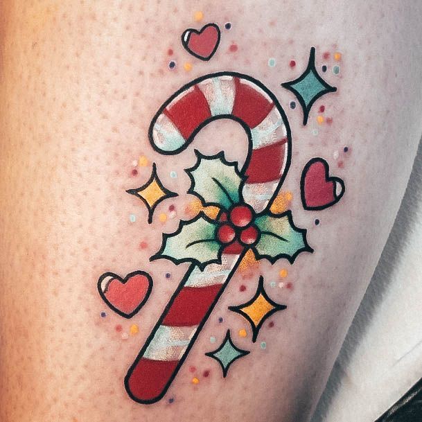 a candy cane tattoo on the thigh