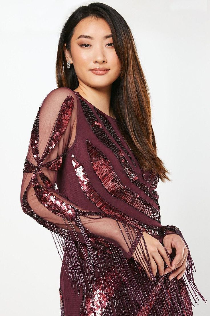 Exquisite hand-embellished sequin detailing Alluring sheer long sleeves Glamorous fringe trim for movement Figure-flattering mini length Intricate pattern placement for a striking effect Make a dazzling entrance at your next formal event with this show-stopping mini dress from Coast. The hand-embellished sequins catch the light beautifully, creating a mesmerising effect as you move. The sheer long sleeves add a touch of allure, while the fringe trim adds drama and movement to your ensemble. Perfect for weddings, races, or any sophisticated soirée, this dress demands attention. Style it with strappy heels and statement earrings for a look that radiates elegance. The mini length showcases your legs, while the intricate pattern placement ensures all eyes are on you. This dress is a testamen Girls Occasion Dresses, Burgundy Mini Dress, Bridal Jumpsuit, Black Tie Dress, Tall Dresses, Floral Shirt Dress, Prom Outfits, Feather Dress, Puff Sleeve Dresses