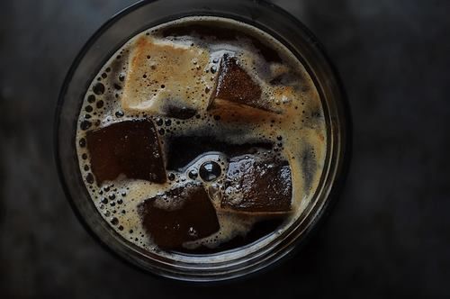 an overhead view of a drink with ice cubes