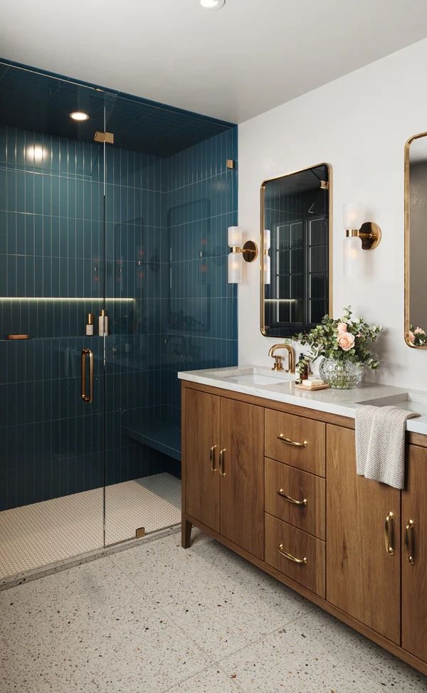 a bathroom with blue tile and wooden cabinets