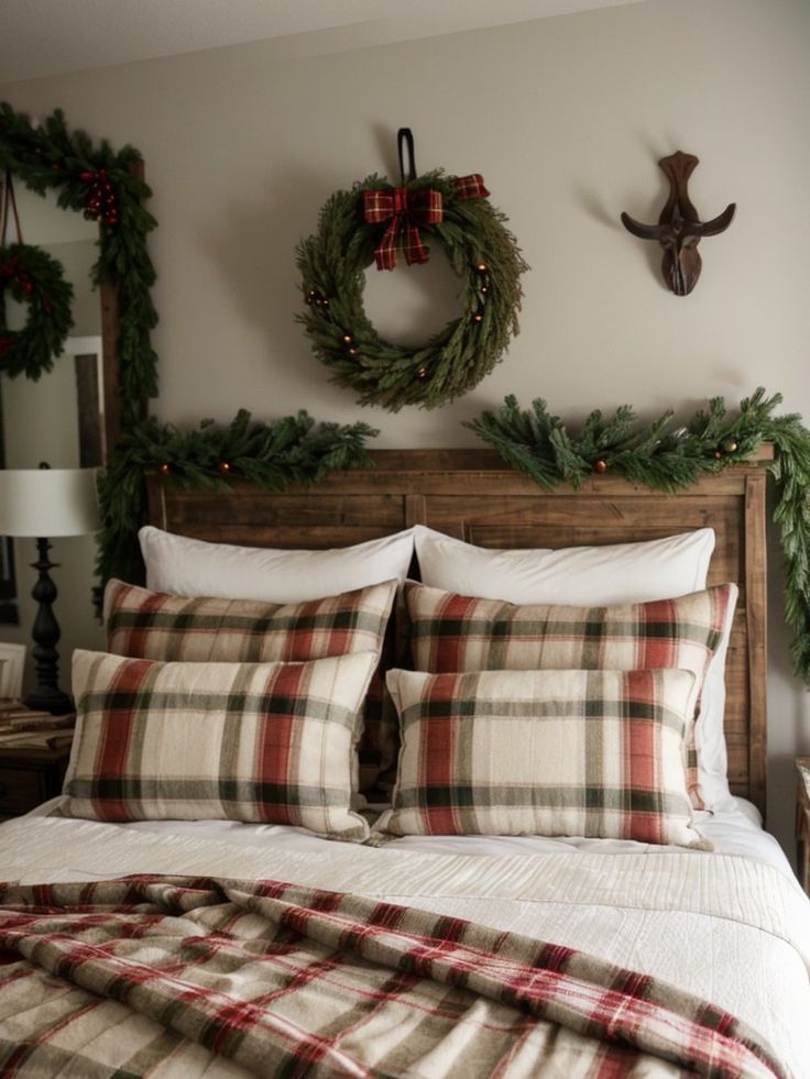 a bed with plaid pillows and christmas wreaths on the headboard