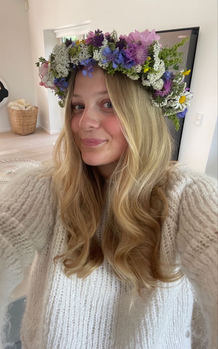 a woman wearing a flower crown on her head