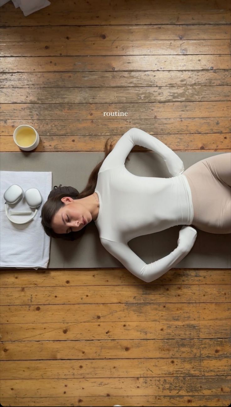 a woman laying on top of a yoga mat