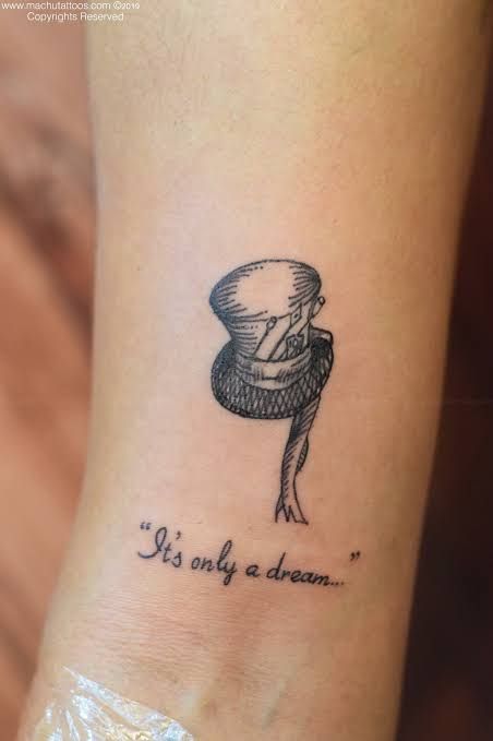 a woman's foot with a tattoo saying it's only a dream