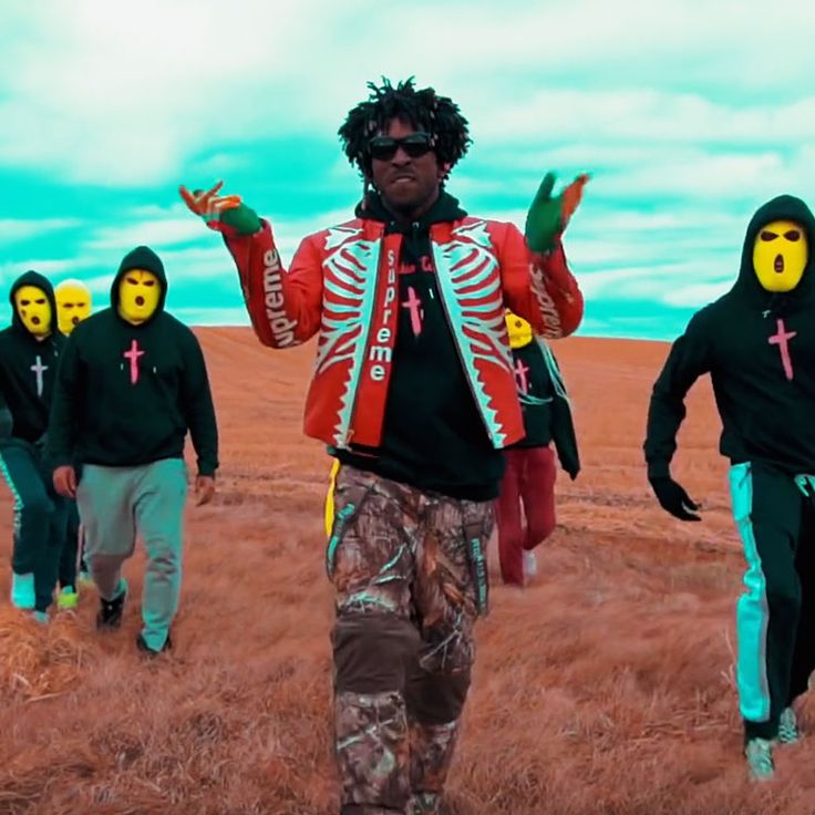 a group of people with painted faces walking across a field