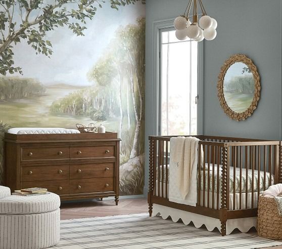 a baby's room with a crib, dresser and chair in it that has a painting on the wall