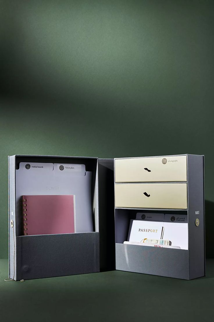 an open box containing two file folders and a binder on the inside is shown