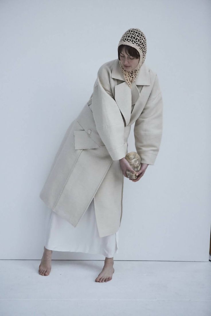 This sweeping statement coat exudes oversized elegance with its wide lapels leading to a romantic deep V neckline. Falling just above the ankles, the Snegurochka Cream Wool Hemp Shell Buttons Coat is both cozy and sophisticated. Made from a blend of durable hemp and wool fibers, its sturdy structure is punctuated with uniquely handcrafted ceramic shell buttons. Lined.Composition 40% Hemp 60% Wool and it´s undyed.Lining 100% viscoseTrimming 100% ceramic glazed handmade shell buttonsSizesOversize. Ceramic Shell, Cream Coat, Kids Garments, Statement Coat, Plus Size Party Dresses, Knit Bottom, Shoe Inspiration, Handcrafted Ceramics, Shell Buttons