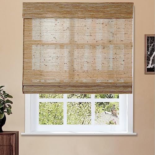 a living room with a window covered in roman shades and a potted plant next to the window