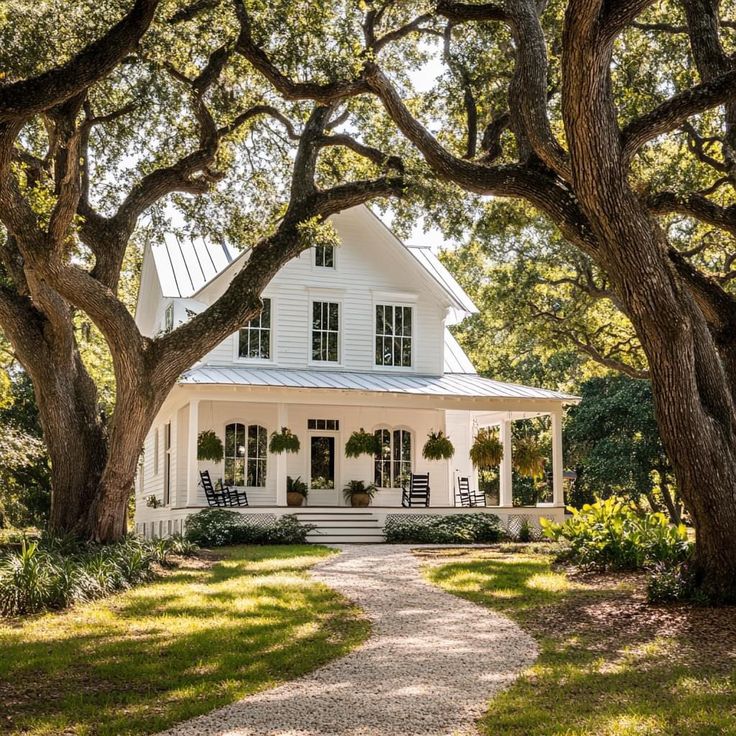 a white house surrounded by trees and grass