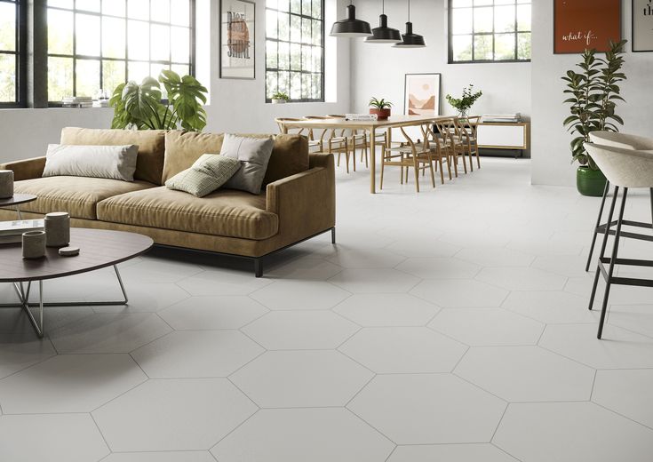 a living room filled with lots of furniture and decor on top of white flooring