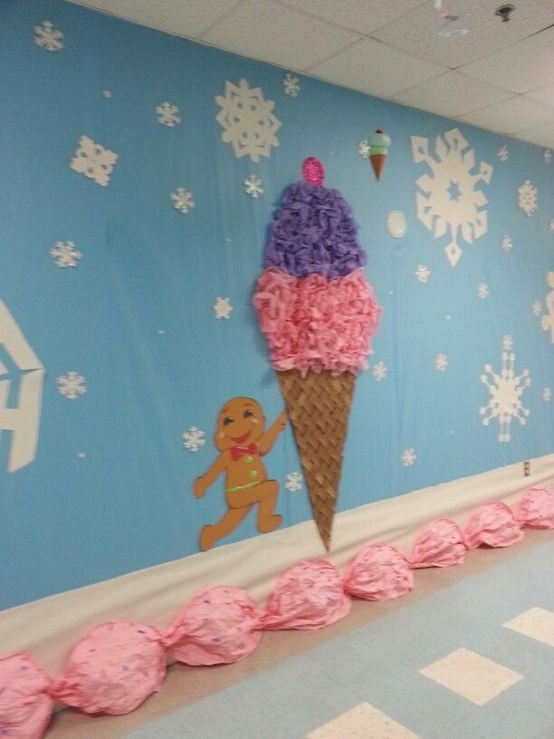 an ice cream cone decorated with pink frosting and purple pom - poms