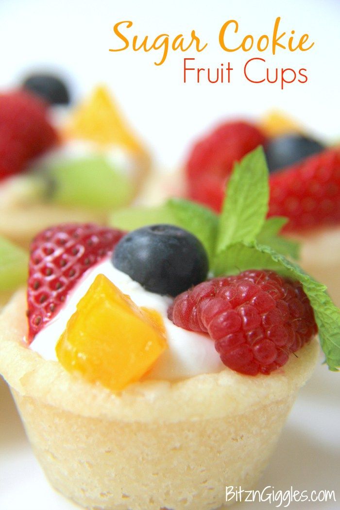 small desserts with fruit on top are arranged in the shape of cupcakes