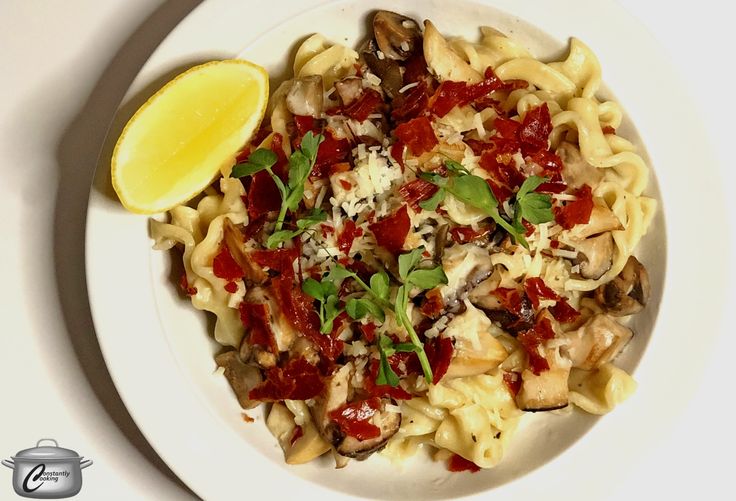 a white bowl filled with pasta and vegetables