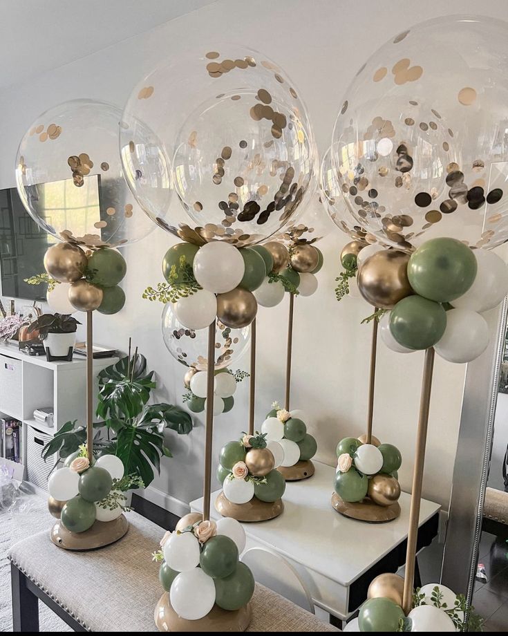 several clear balloons with gold and white confetti on them in front of a mirror