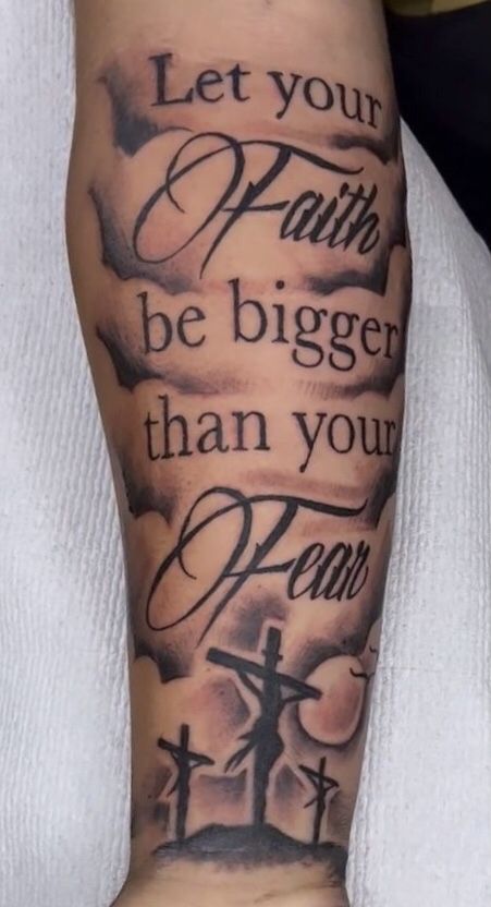 a person with a tattoo on their arm that says let your faith be bigger than your fear