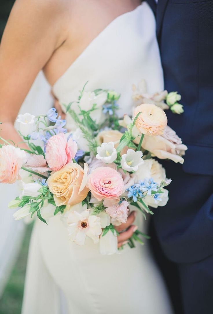 the bride and groom are holding their wedding bouquet