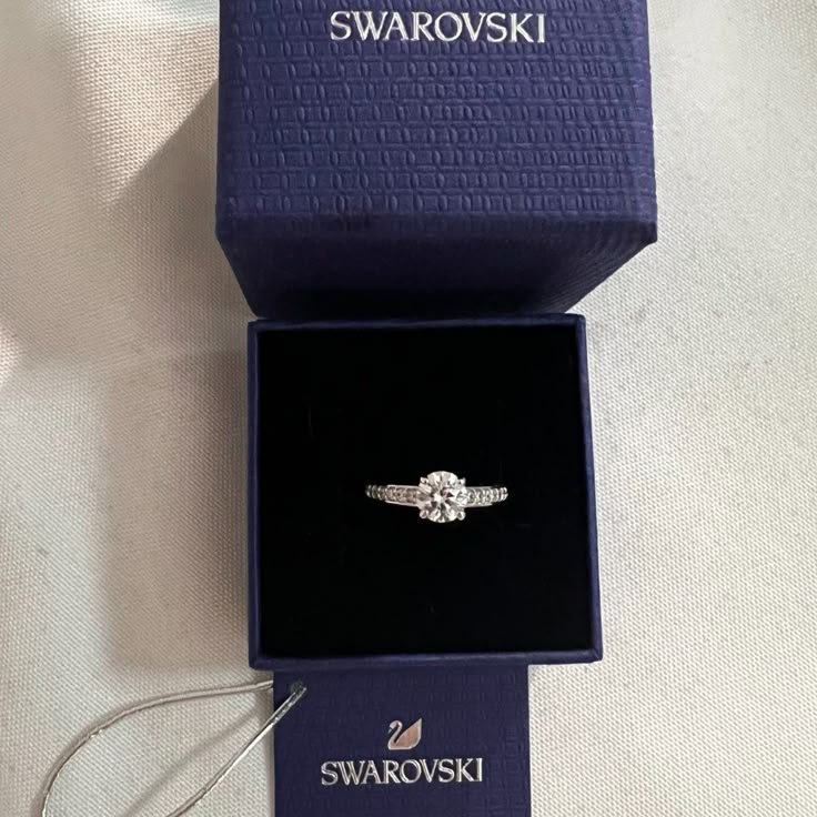 Swarovski Crystal Attract Ring Size 5.5. Brand New With Tag. Offers Welcome! See Our Photos For Details. Item #05759862 From Swarovski, This Ring Features: Swarovski's Attract Round Ring Is A Truly Romantic Gift. This Stunning, Rhodium-Plated Ring Features A Round Crystal In The Center With Sparkling Crystals On Either Side. The Crystals Embellish The Front Half Of The Ring. The Perfect Jewelry Piece For Day Or Evening Outfits! Rhodium-Plated Metal Swarovski Crystal Swarovski Promise Ring, Swarovski Ring Aesthetic, Dainty Wedding Ring Silver, Swarovski Ring Engagement, Swarovski Jewelry Aesthetic, Swarovski Rings, Girlfriend Proposal, Graduation Ring, Swarovski Jewelry Rings