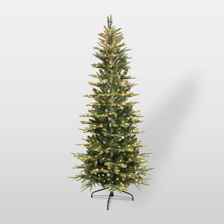 a tall artificial christmas tree with lights on it's sides and a black stand