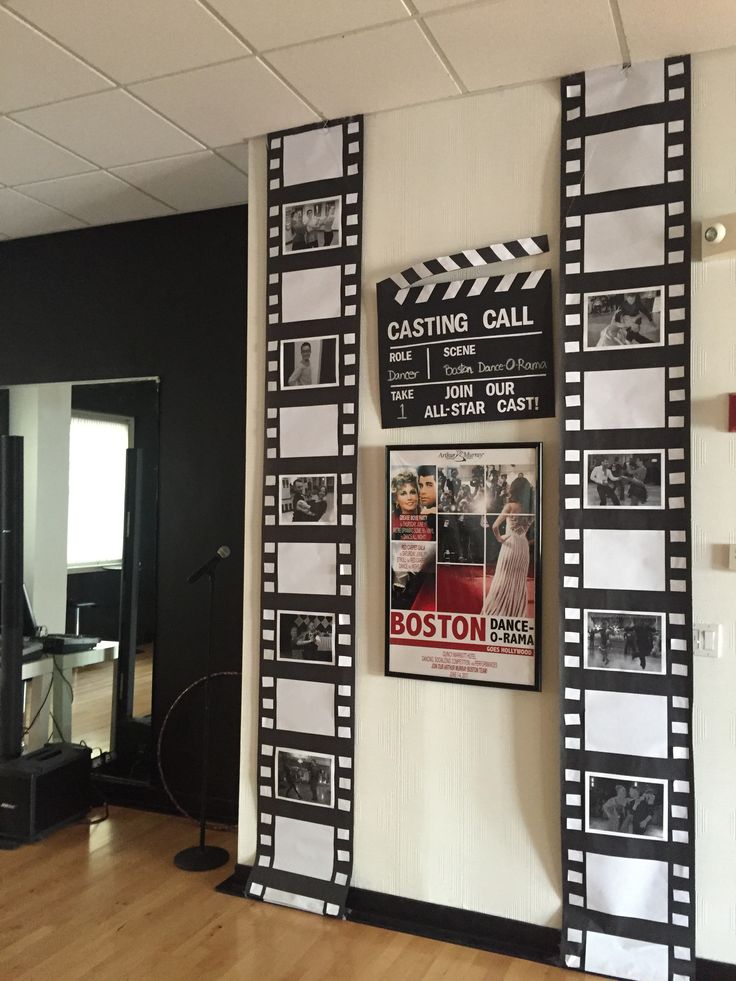 a movie poster is hanging on the wall next to a wooden floor in an office