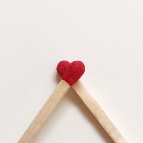 two matchsticks shaped like a heart on top of each other