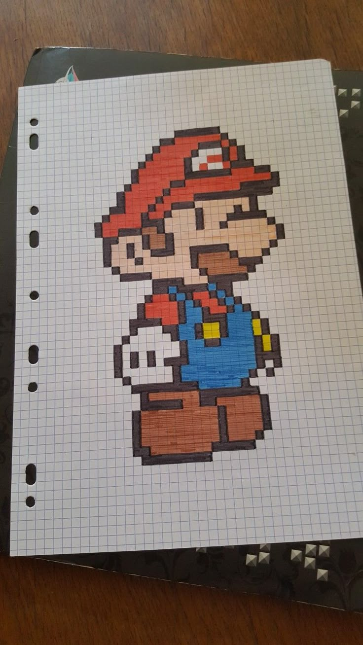 a drawing of an old school mario bros character on a piece of paper with graph paper underneath it