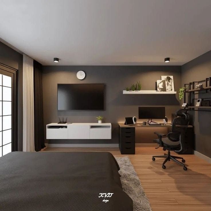 a bedroom with a bed, desk and television on the wall in front of it