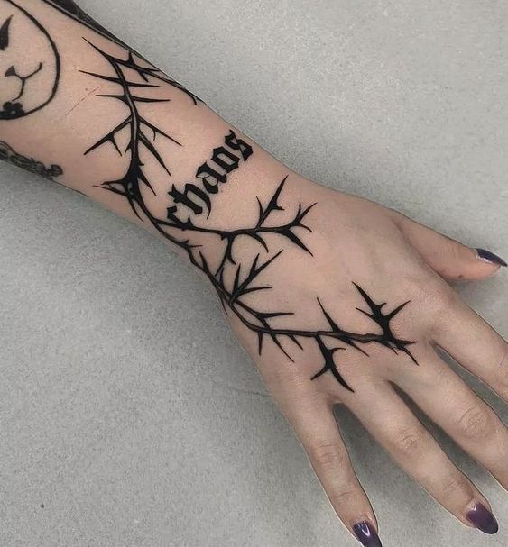 a woman's hand with tattoos on it